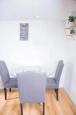 a dining room with a table and chairs at Cozy Haven 2 bedroom Basement apartment with Treated water in London