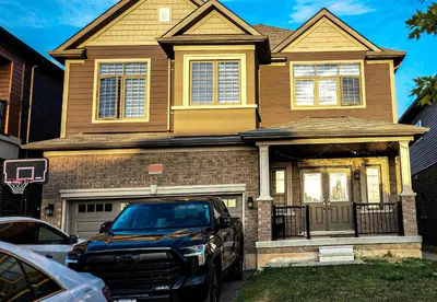 a truck parked in front of a house at Garden Avenue Homes Free Parking in Brantford