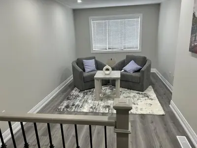 a living room with a couch and a table at Treasure Haven Near Tourism Barrie in Barrie