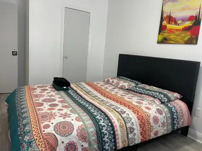 a bed with a quilt on it in a bedroom at Toronto Midtown Room with Queen Bed in Toronto