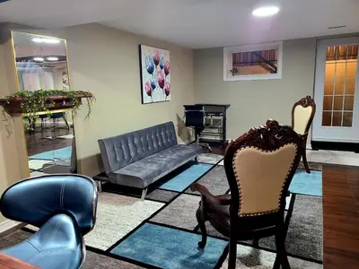 a living room with chairs and a couch at Charm Heaven - Workspace, Wi-Fi, 3-Beds and Private Entrance in Pickering