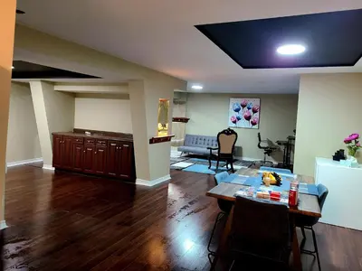 a living room with a table and a couch at Charm Heaven - Workspace, Wi-Fi, 3-Beds and Private Entrance in Pickering