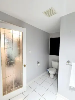 a bathroom with a toilet and a window at Charm Heaven - Workspace, Wi-Fi, 3-Beds and Private Entrance in Pickering
