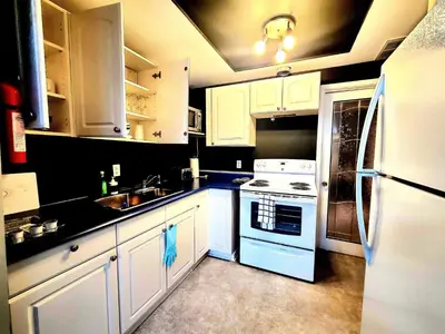 a kitchen with white cabinets and a white refrigerator at Charm Heaven - Workspace, Wi-Fi, 3-Beds and Private Entrance in Pickering