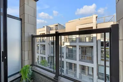 an apartment balcony with a view of a building at Designer Yorkdale 2BR Townhouse, Private Patio, Parking in Toronto