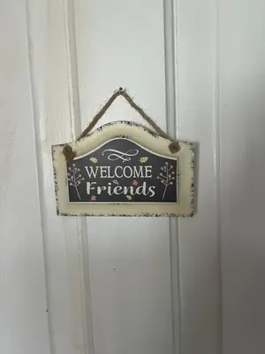 a sign that says welcome friends on a door at The Lakeview Loft in Port Colborne