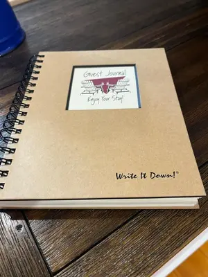 a notebook sitting on top of a wooden table at The Lakeview Loft in Port Colborne