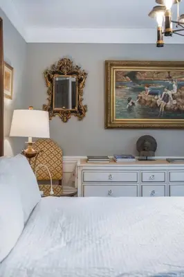 a bedroom with a bed and a painting on the wall at Gate House Comfort plus own lake access, dock, 4 mins to beach in West Lake