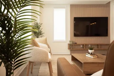 a living room with a tv and a couch and a table at Spotless 4 bed and 3 bath with Wi-Fi and 1hr to Niagara in Hamilton