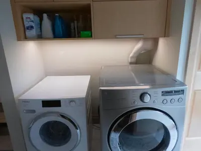a washer and a washing machine in a kitchen at Riverside Retreat with Sauna & Hot Tub in Elora in Elora