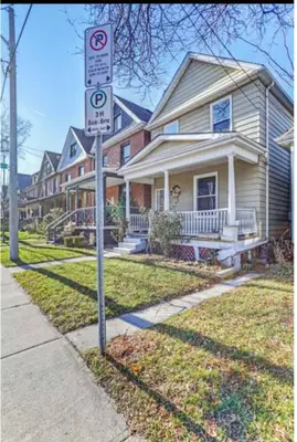 a no parking sign in front of a house at H men's dormitory in Hamilton