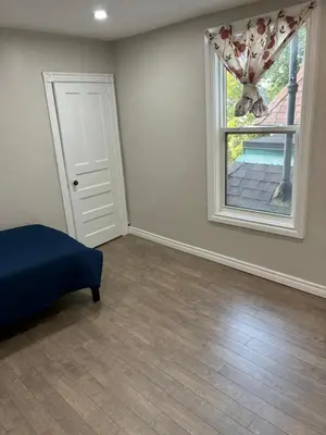 a bedroom with a bed and a window at H men's dormitory in Hamilton