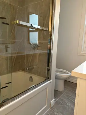 a bathroom with a shower and a toilet at H men's dormitory in Hamilton