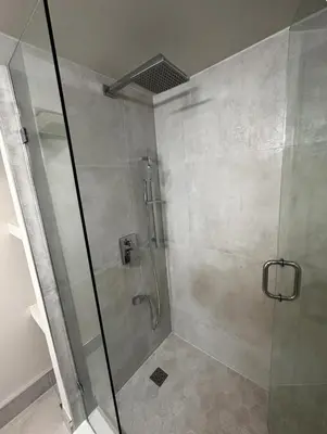 a shower with a glass door in a bathroom at Pvt Studio Near Waterloo Airport & Minutes to Downtown Basement unit in Kitchener