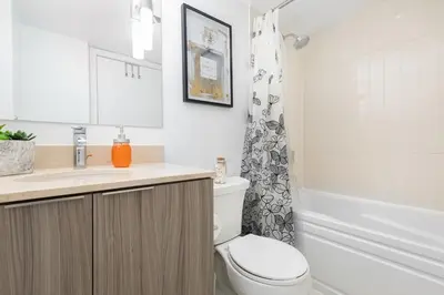 a bathroom with a toilet and a sink and a shower at Modern Micro Studio in Heart of Downtown in Toronto