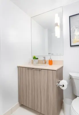 a bathroom with a sink and a mirror at Modern Micro Studio in Heart of Downtown in Toronto