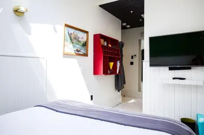 a bedroom with a bed and a flat screen tv at Drake Devonshire and Motor Inn in Wellington