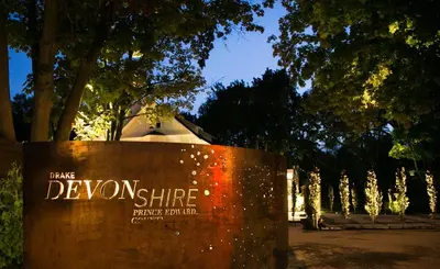 a sign with the words denning shine on it at Drake Devonshire and Motor Inn in Wellington