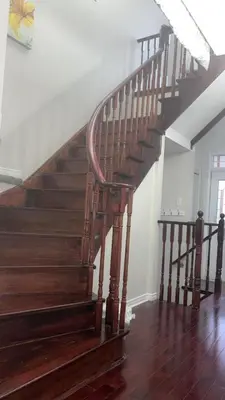 a wooden staircase in a home with wooden floors at Near Toronto Pearson Airport Queen Room in Brampton