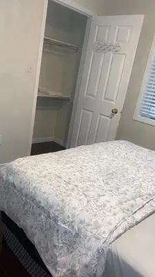 a bedroom with a white bed and a white door at Near Toronto Pearson Airport Queen Room in Brampton
