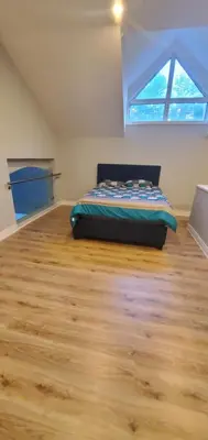 a bedroom with a bed in a room with a window at Luxury Vacation Home in Stouffville