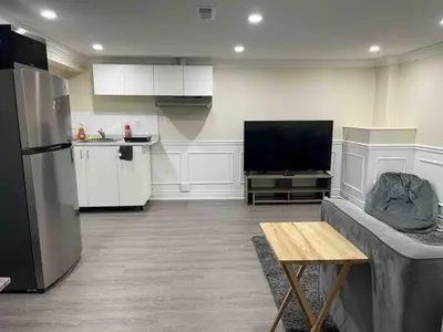 a kitchen with a refrigerator and a table in a room at Full Privacy Entire basement,kitchen,1parking in Oshawa