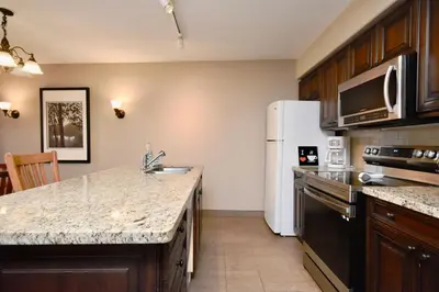 a kitchen with a sink and a refrigerator at Relaxing 2BR Retreat at Carriage Hills in Edgar
