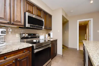 a kitchen with a stove and a microwave at Relaxing 2BR Retreat at Carriage Hills in Edgar