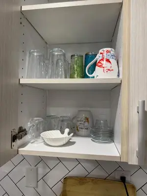 a cupboard filled with lots of glass items at 1 bedroom cozy apartment in Kitchener