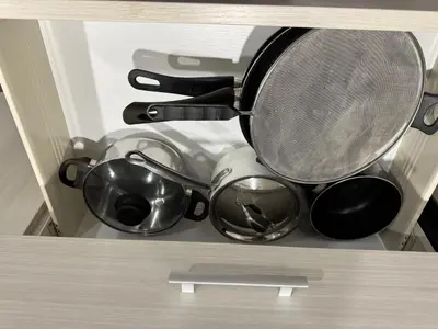 a bunch of pots and pans in a drawer at 1 bedroom cozy apartment in Kitchener