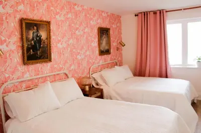 a bedroom with two beds and a painting on the wall at Boutique Accommodation in PEC - Suite 4 in Belleville