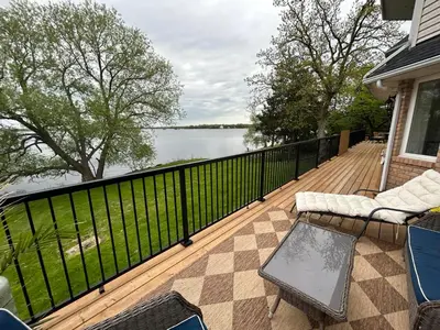 a deck with a view of the water on a house at Boutique Accommodation in PEC - Suite 4 in Belleville