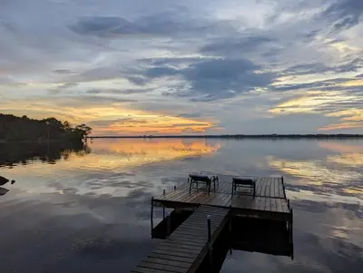 two chairs sitting on a dock on a lake at Boutique Accommodation in PEC - Suite 4 in Belleville