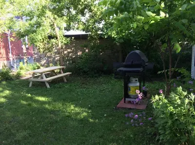 a picnic table and a grill in a yard at Charming Farmhouse in the City, Near Wine Country in Belleville