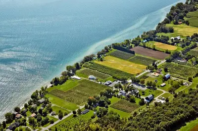 an aerial view of a farm next to the water at Charming Farmhouse in the City, Near Wine Country in Belleville