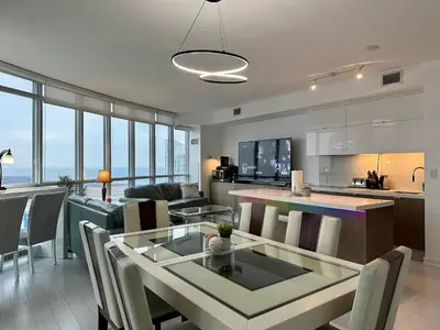 a kitchen and living room with a table and chairs at Cityview in the Sky 2Bdrms 2Baths 5realbeds in Toronto