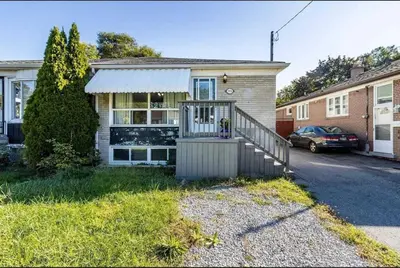 a house with a gate in front of it at Quaint and Cozy Haven in Toronto