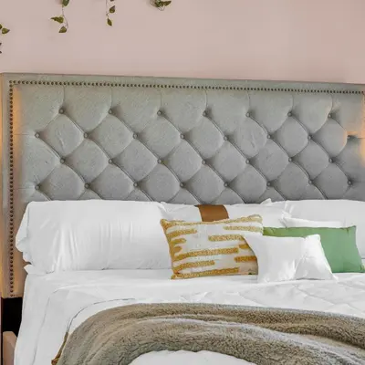 a bedroom with a large bed with white sheets and pillows at Retro Arcade & Gaming Home by Pako Stays in Brampton