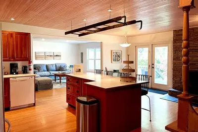 an open kitchen and living room with a couch at Gwyn Haven - Spacious Charming Century Home in Wellington in Wellington