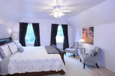 a bedroom with a bed and a ceiling fan at Gwyn Haven - Spacious Charming Century Home in Wellington in Wellington
