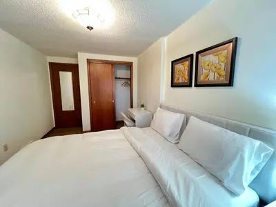 a bedroom with a large bed with white pillows at Entire Cozy House in Thorold in Thorold