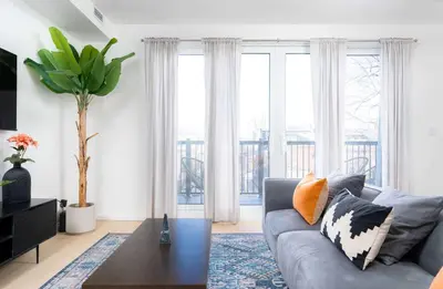 a living room with a couch and a table at Large Victorian Sleeps 6 by UofT in Toronto