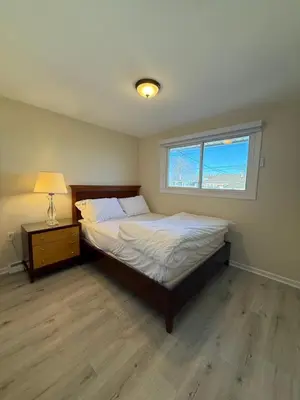 a bedroom with a bed and a window at Niagra Luxury Home in Thorold
