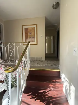 a stairway with a railing and a stair case at Niagra Luxury Home in Thorold