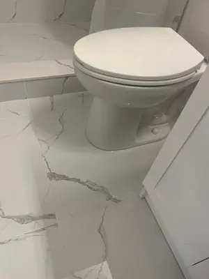 a white toilet in a bathroom with marble floors at Cozy Home away in Ajax 2 BR 1 bath 4 guests in Ajax
