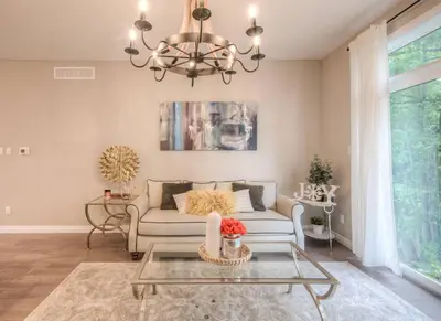 a living room with a couch and a chandelier at BRAND-NEW LUXURY SUITE in DOON SOUTH, min to 401 in Kitchener