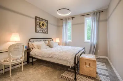 a bedroom with a bed and a desk and a chair at BRAND-NEW LUXURY SUITE in DOON SOUTH, min to 401 in Kitchener