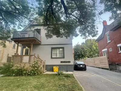 a house with a balcony on the side of it at Stylish 3-bdrm suite w free Parking in Kitchener
