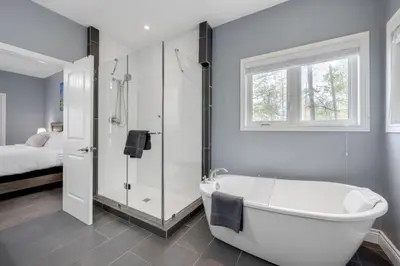 a bathroom with a tub and a shower and a bed at LUX Lakefront Sleeps18 Pickleball HotTub Sauna Gym Arcade Basketball Volleyball in Buckhorn