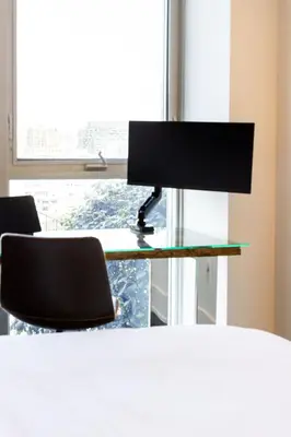 a computer monitor sitting on a desk in front of a window at PARC LOFT Penthouse with 4bd-WFH-PS5-CN Tower Views in Toronto